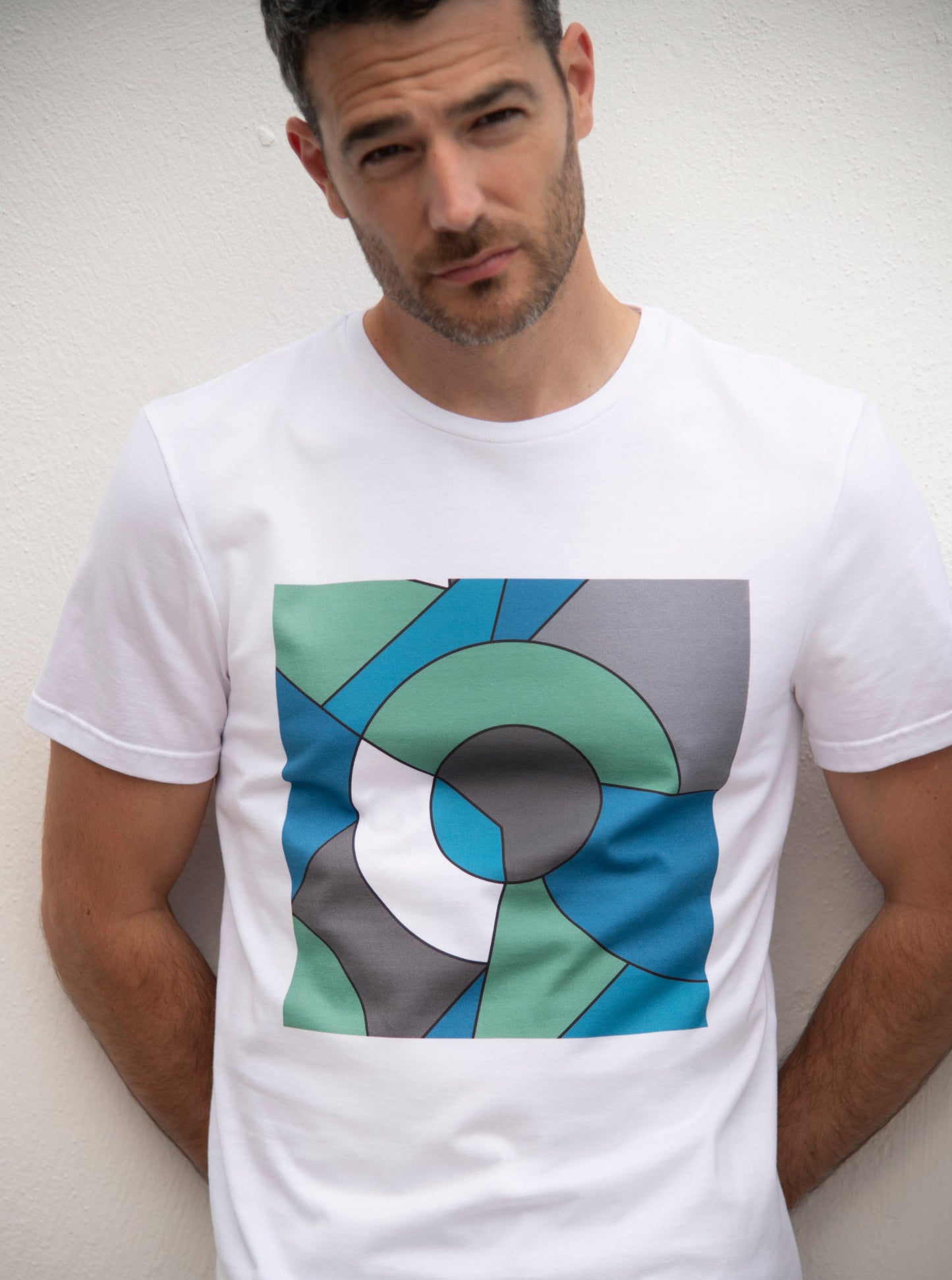 white cotton t-shirt with square print in geometric shapes of green, blue and grey