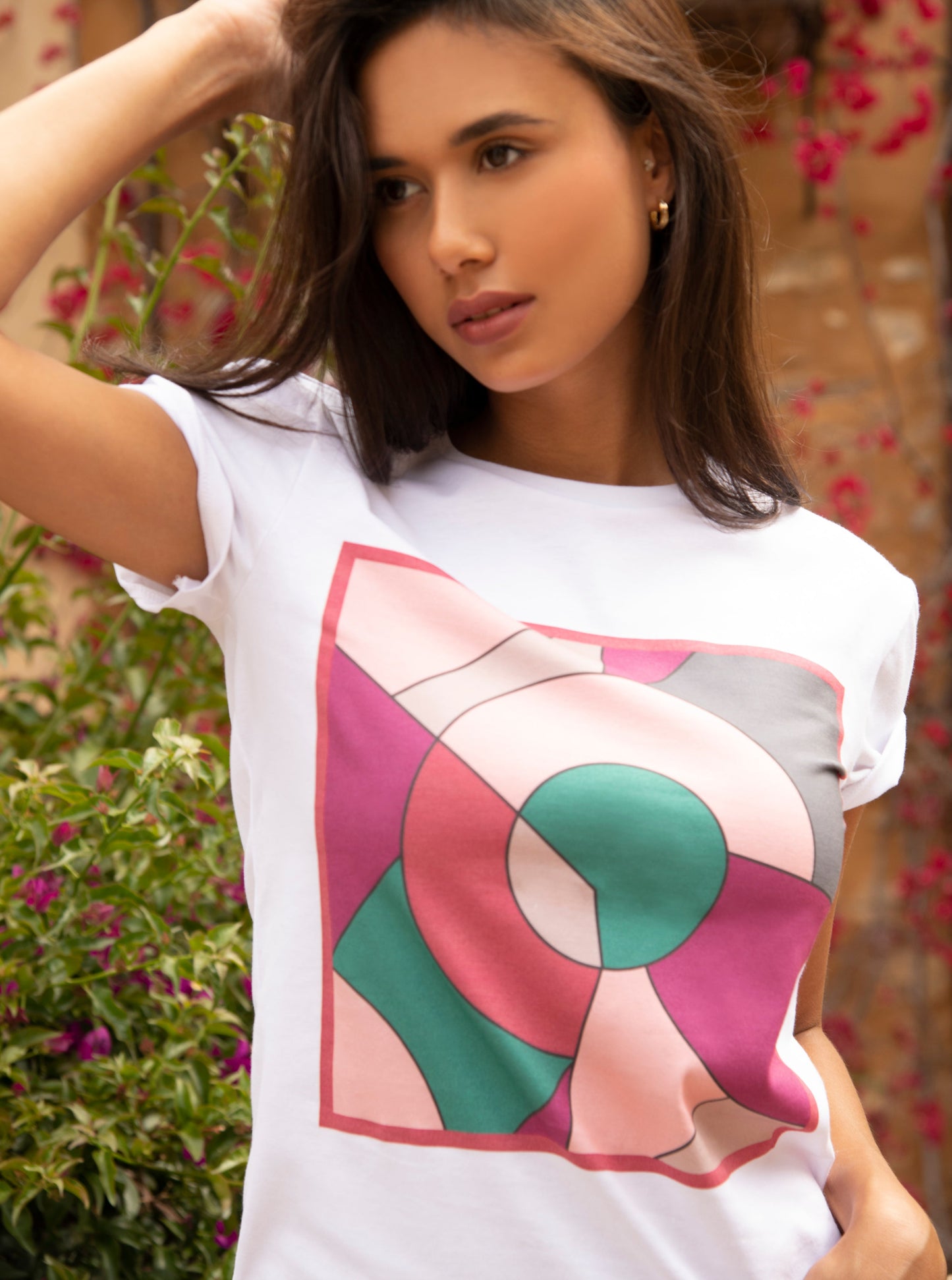 white cotton t-shirt with square print in geometric shapes in green , rosa, red and fushia